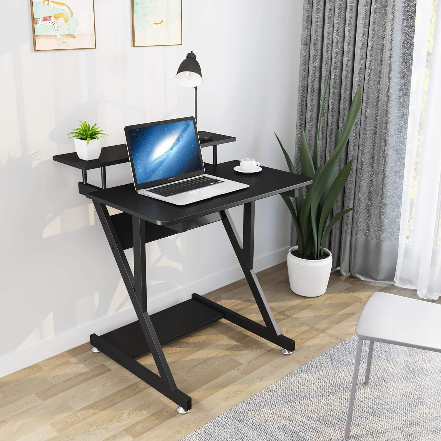 Dripex black Z-shaped computer desk with monitor shelf, storage shelves, and movable wheels for small home office spaces.