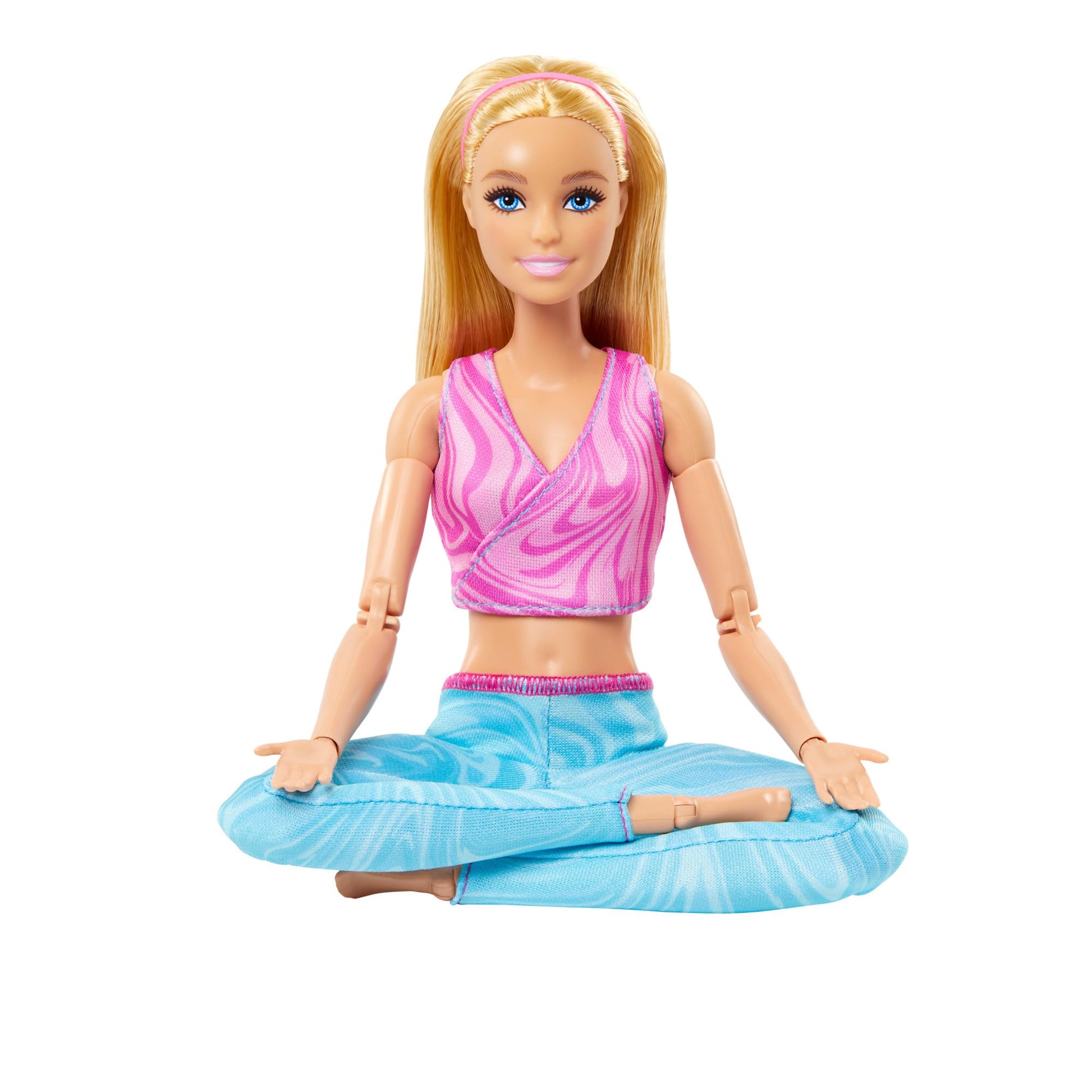 Barbie Made to Move doll with blonde hair in pink sports top and blue yoga pants, showcasing 22 bendable joints.