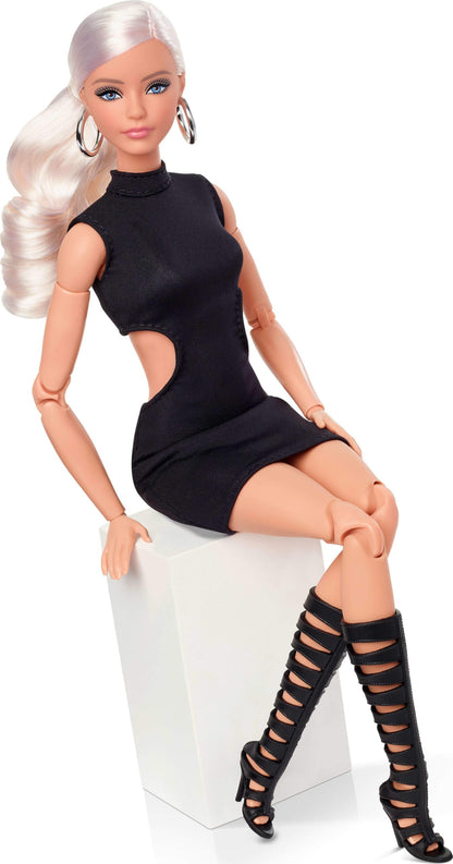 Barbie Mattel Basics Model 02 collector doll with blonde hair, black mini dress, gladiator boots, posable body, and swappable head.