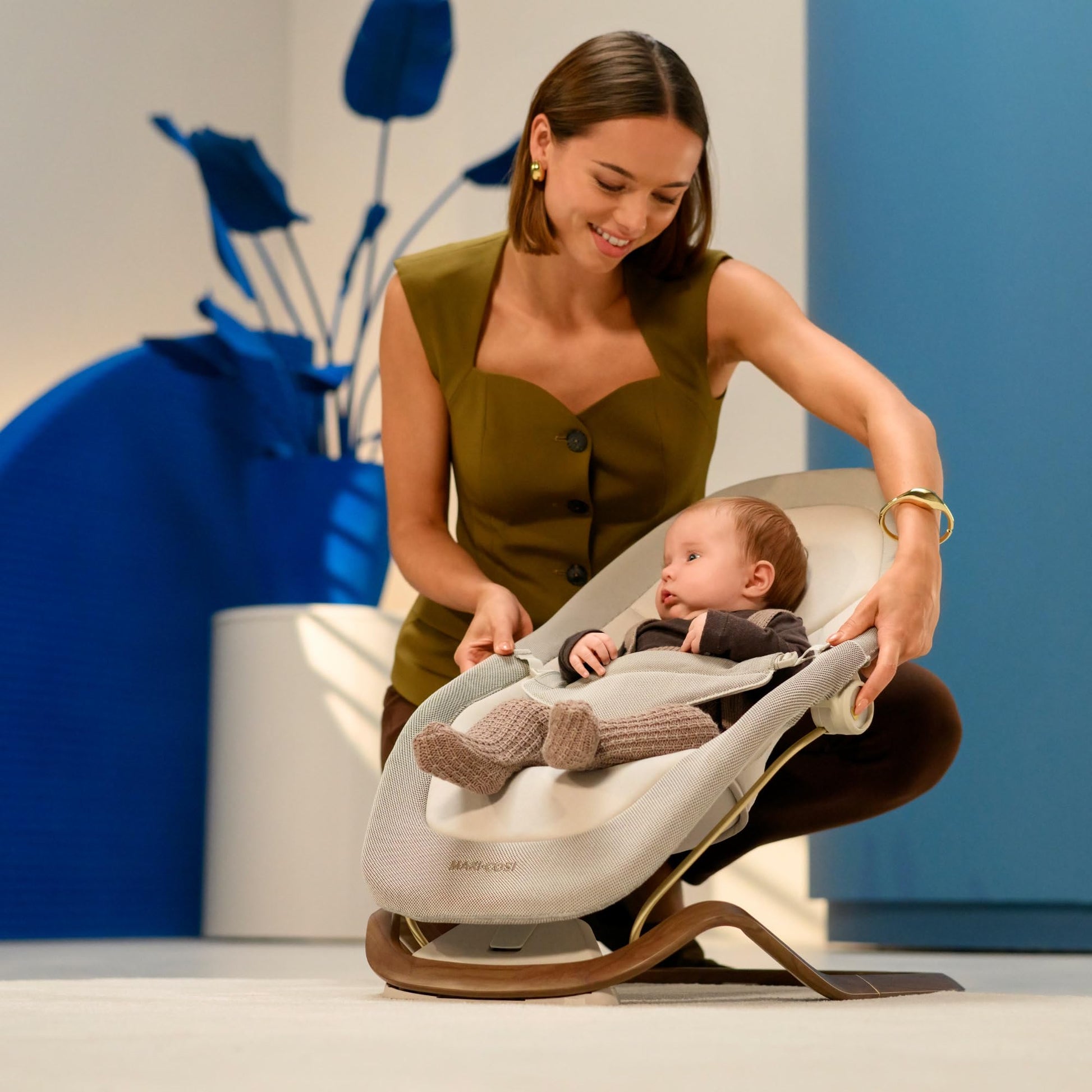 Maxi-Cosi Dove baby bouncer in beige with natural bouncing feature, foldable and portable, made from eco-friendly recycled fabrics for ages 0-3.