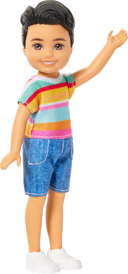 Barbie Club Chelsea Koji 6-inch boy doll with brunette hair, striped shirt, shorts, and shoes, standing against a plain background.