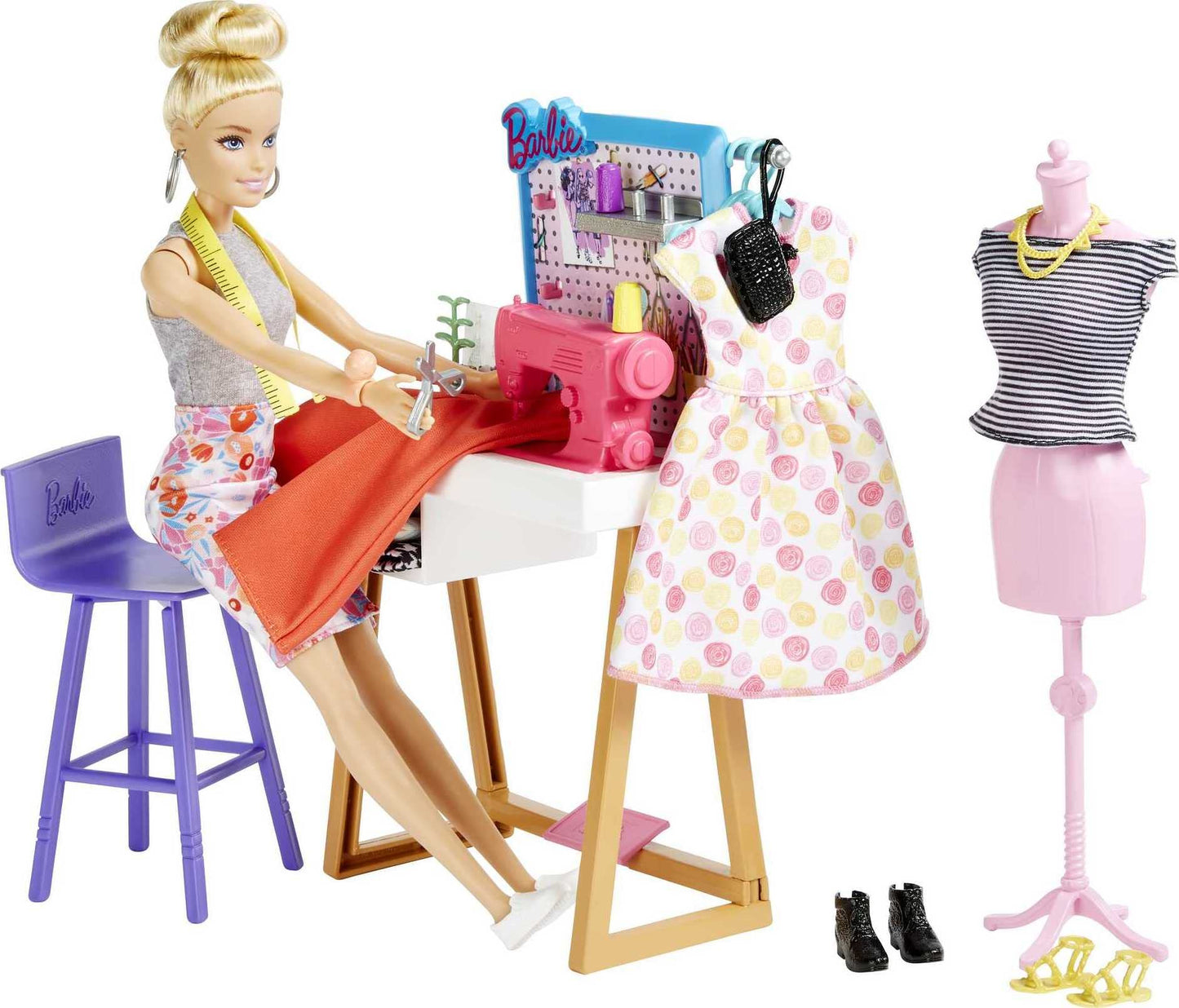 Barbie Fashion Designer Doll set with design desk, chair, sewing machine, mannequin, and fashion accessories.
