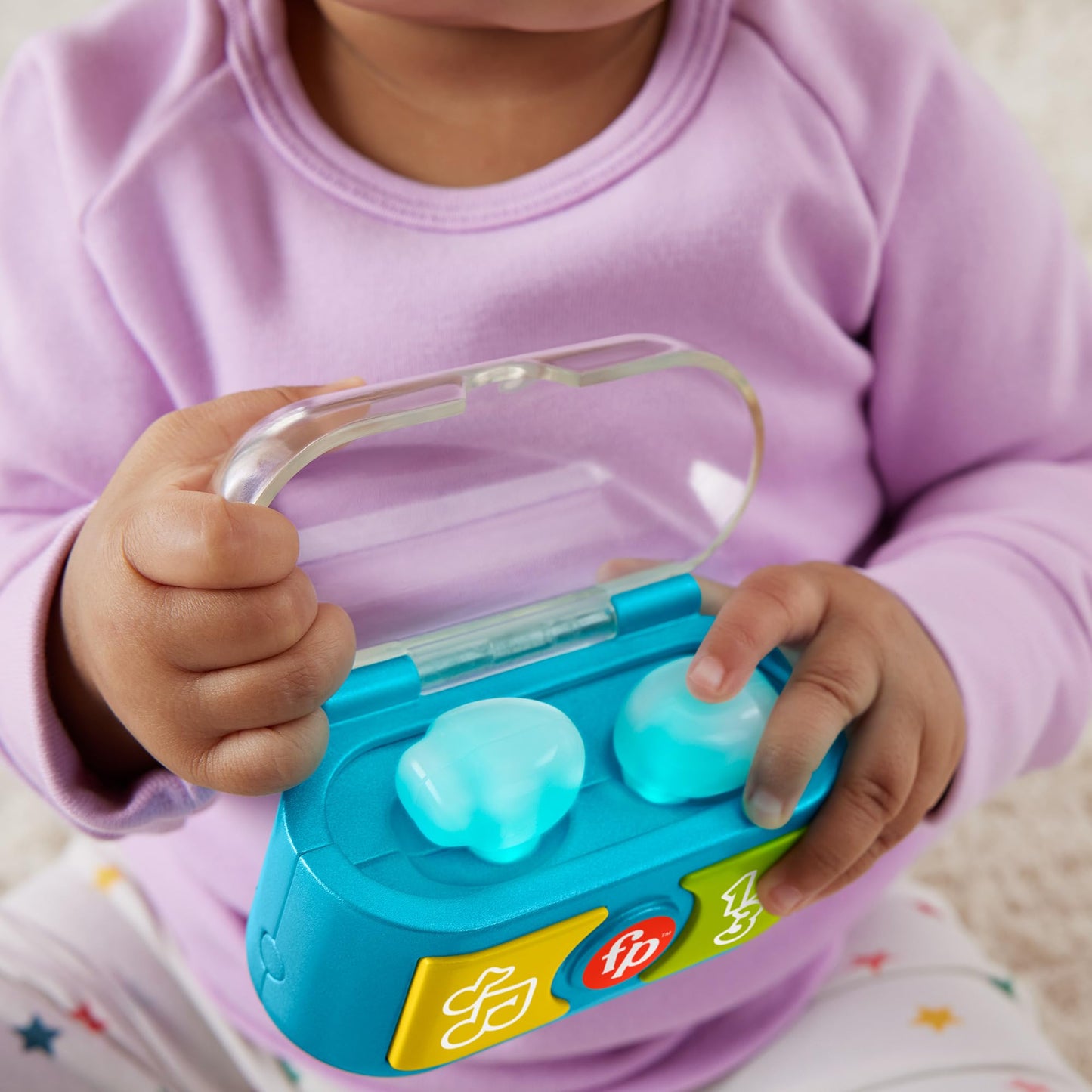 Fisher-Price Laugh & Learn baby toy with colorful ear buds, music, and lights for ages 6+ months, multilingual version.