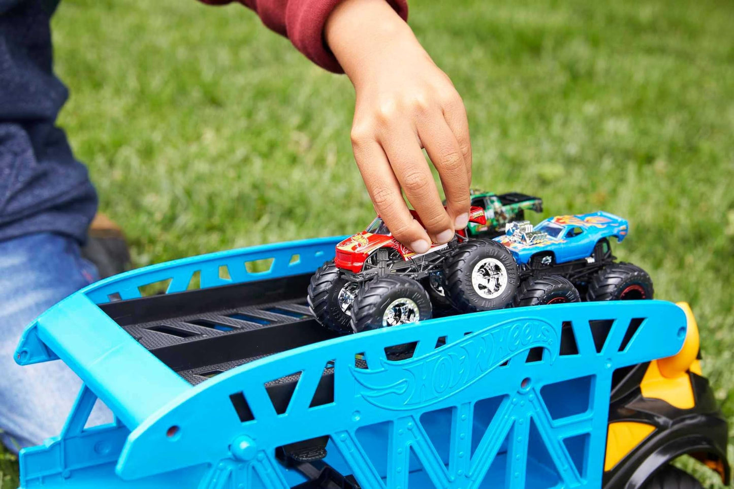 Hot Wheels GGB64 Monster Trucks set featuring three multicoloured toy cars displayed together on a white background.