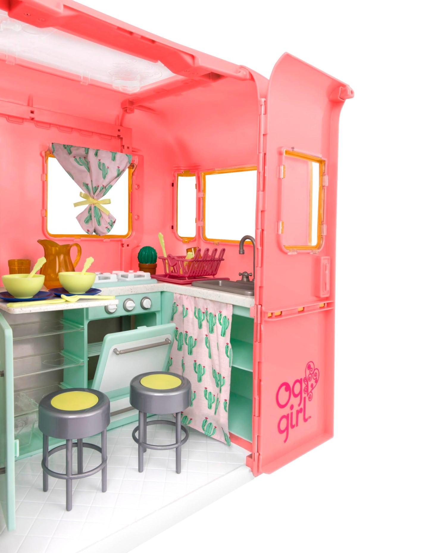 Our Generation pink camping trailer with kitchen accessories for 18-inch dolls, ideal for pretend play.