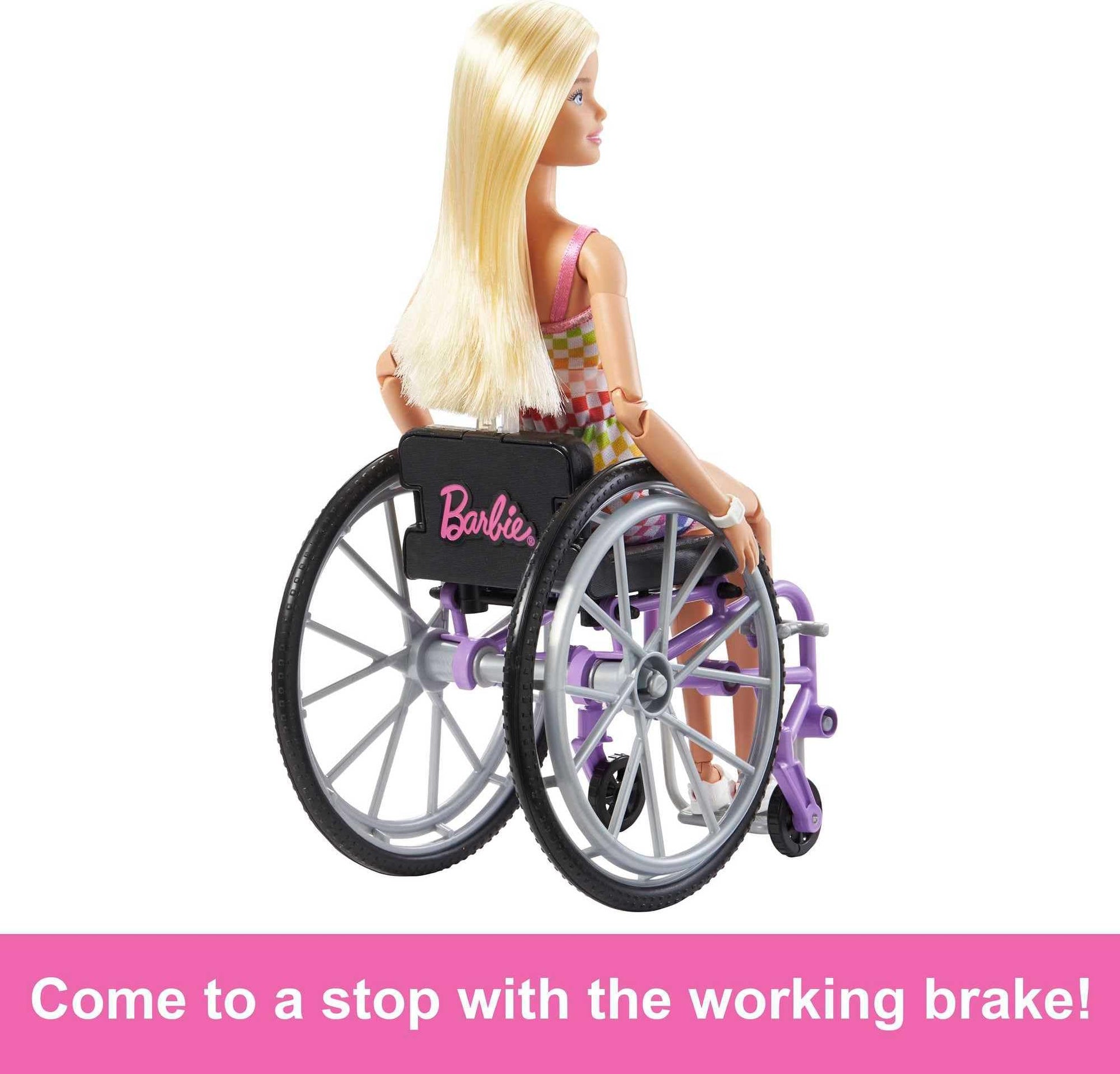 Barbie Fashionistas doll with blonde hair in a rainbow romper, accompanied by a wheelchair and ramp for kids' play.