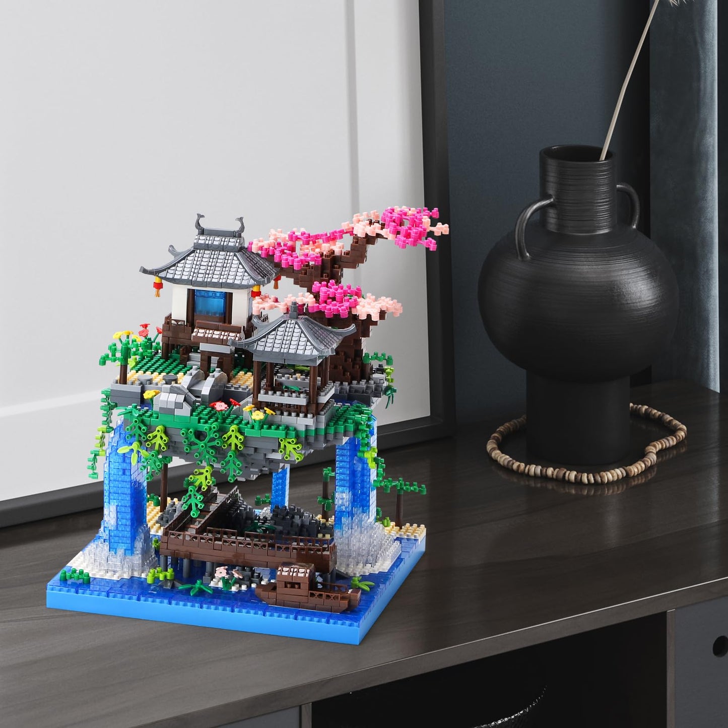CAXIMSY Cherry Blossom Bonsai treehouse building block set with 3300 pieces, showcasing detailed architecture and vibrant colors.