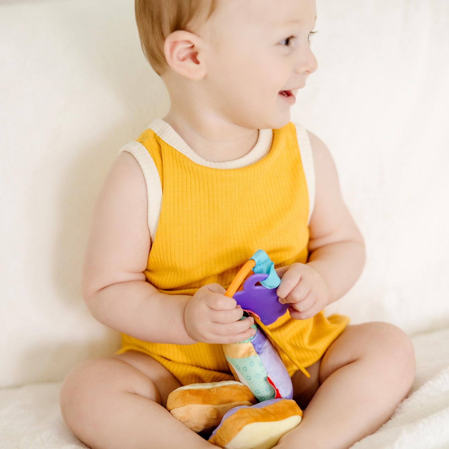 Melissa & Doug multi-sensory PB&J take-along clip-on baby toy with colorful textures for infants and toddlers, suitable for 0+ age.