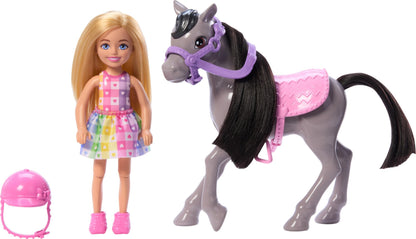 Barbie Chelsea doll and gray toy horse set with helmet and saddle, small doll bending knees to simulate riding.