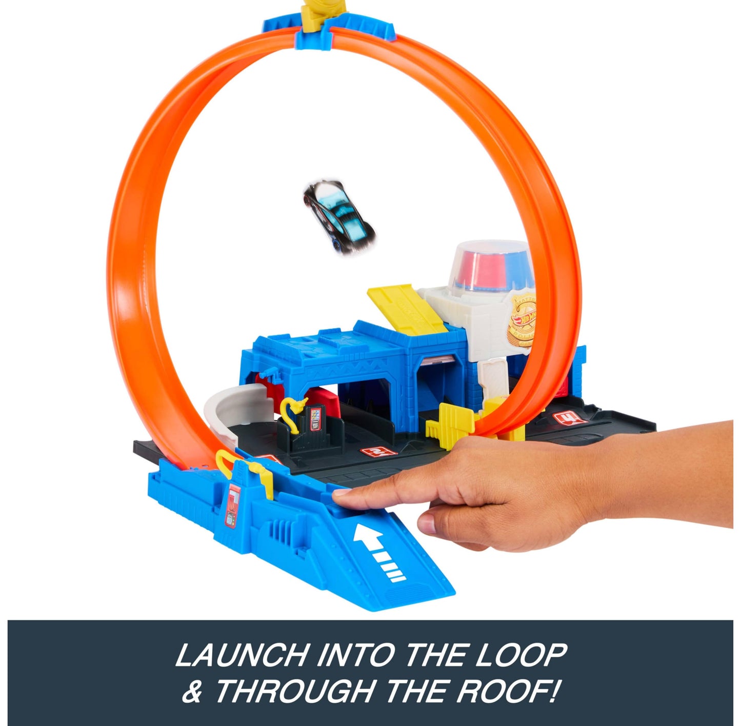 Hot Wheels Super Police Station playset with adjustable loop and 1:64 scale die-cast vehicle in action on the track.