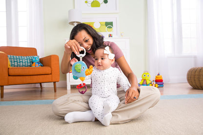 LAMAZE Mini Eloy the Elephant baby toy clipped to a pram, sensory toy for newborns 0-6 months, soft plush with colorful details.