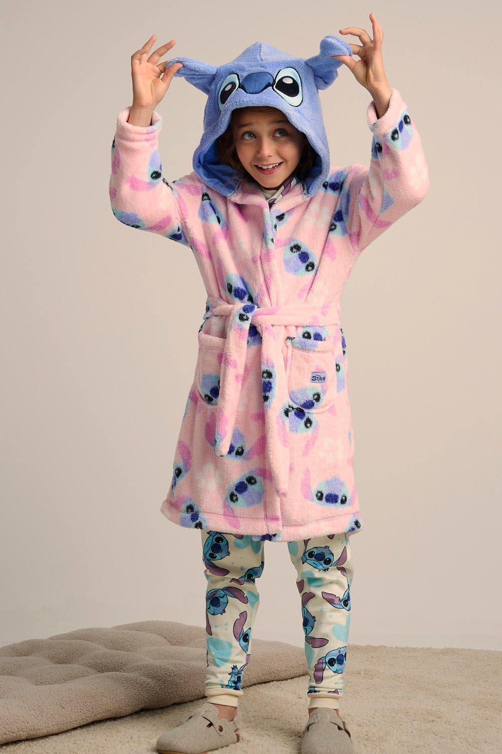 Disney girls Stitch fleece dressing gown featuring 3D ears, floral print, tie belt, and pockets, perfect for cozy loungewear.