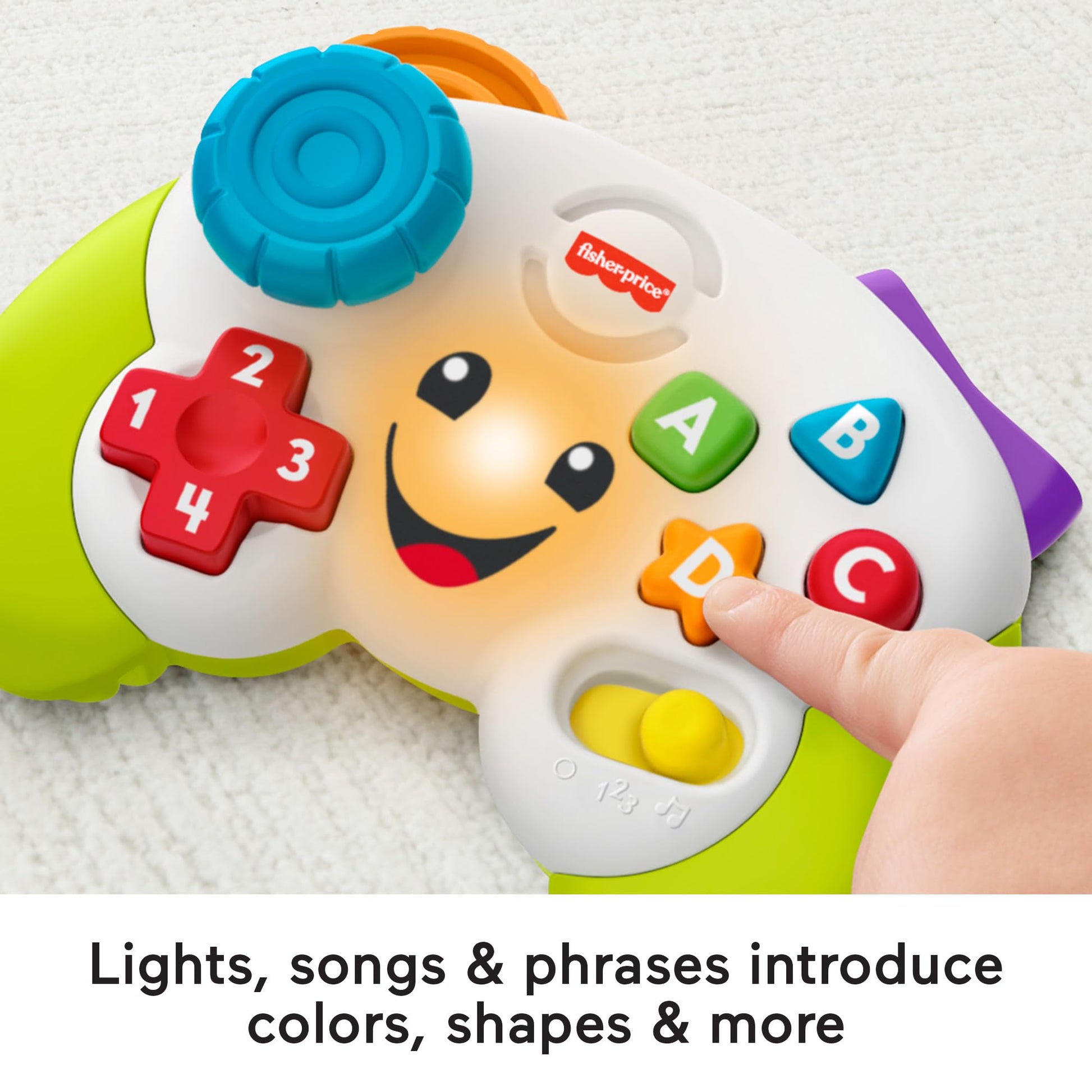 Fisher-Price Laugh & Learn baby toy controller in green with musical buttons, designed for infants aged 6 months and up.