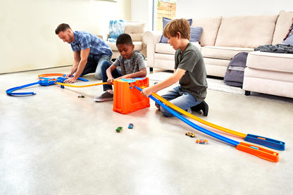 Hot Wheels Track Builder Deluxe Stunt Box with over 5 meters of track, dual launchers, and two toy cars for ages 6 and up.