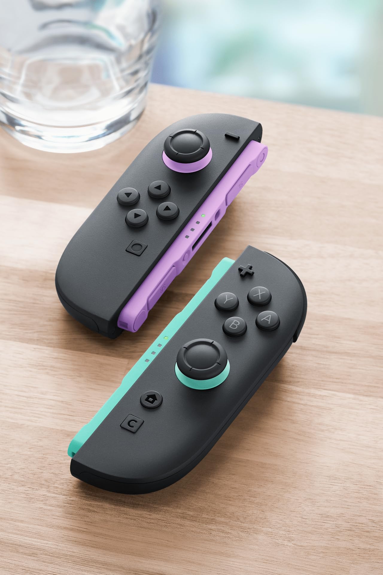 Nintendo Joy-Con controllers in light purple and light green, showing the left and right gamepad sides with colorful buttons.
