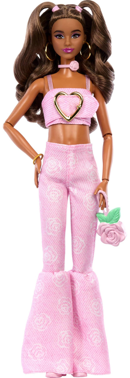 Barbie Deluxe Style Doll #12 in pink denim crop top and rose print flare jeans, with wavy brown hair and accessories.