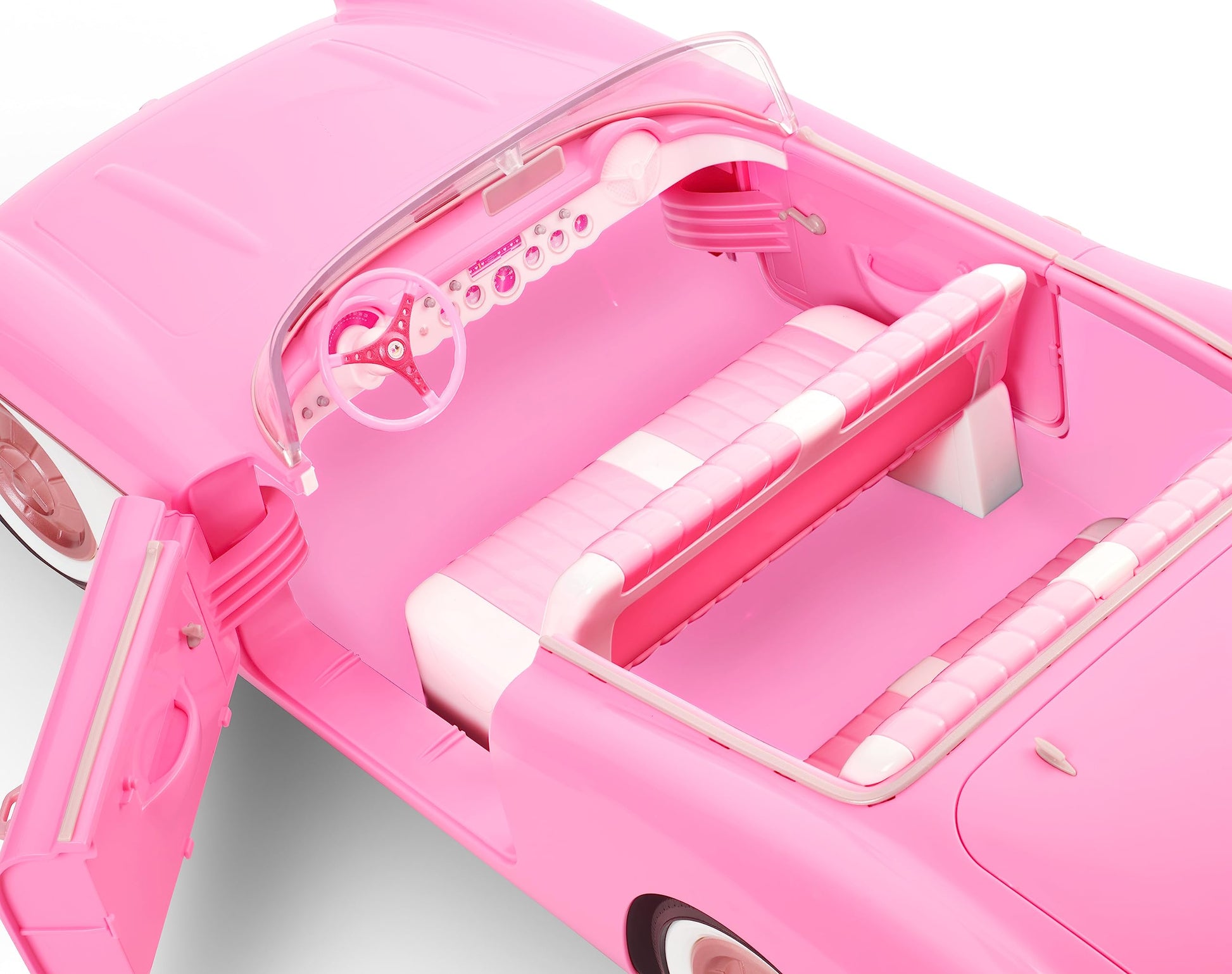 Vintage-inspired Barbie pink Corvette convertible with white wall tires and trunk storage, collectible toy car.