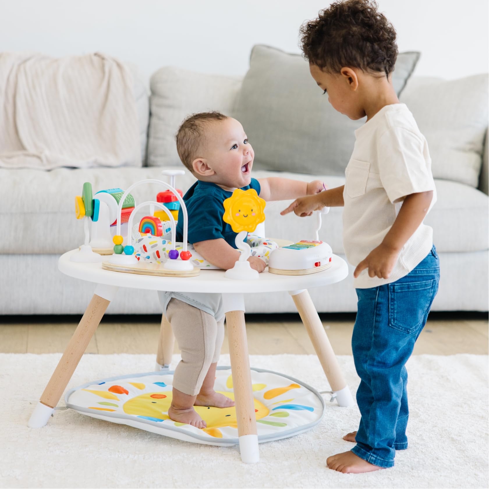 Move2Play 4-in-1 baby activity center with colorful toys, tummy time mat, and jumper for infants 3-6 months.