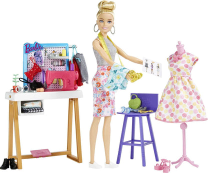 Barbie Fashion Designer Doll with studio setup, sewing machine, fabric swatches, and design accessories for creative play.