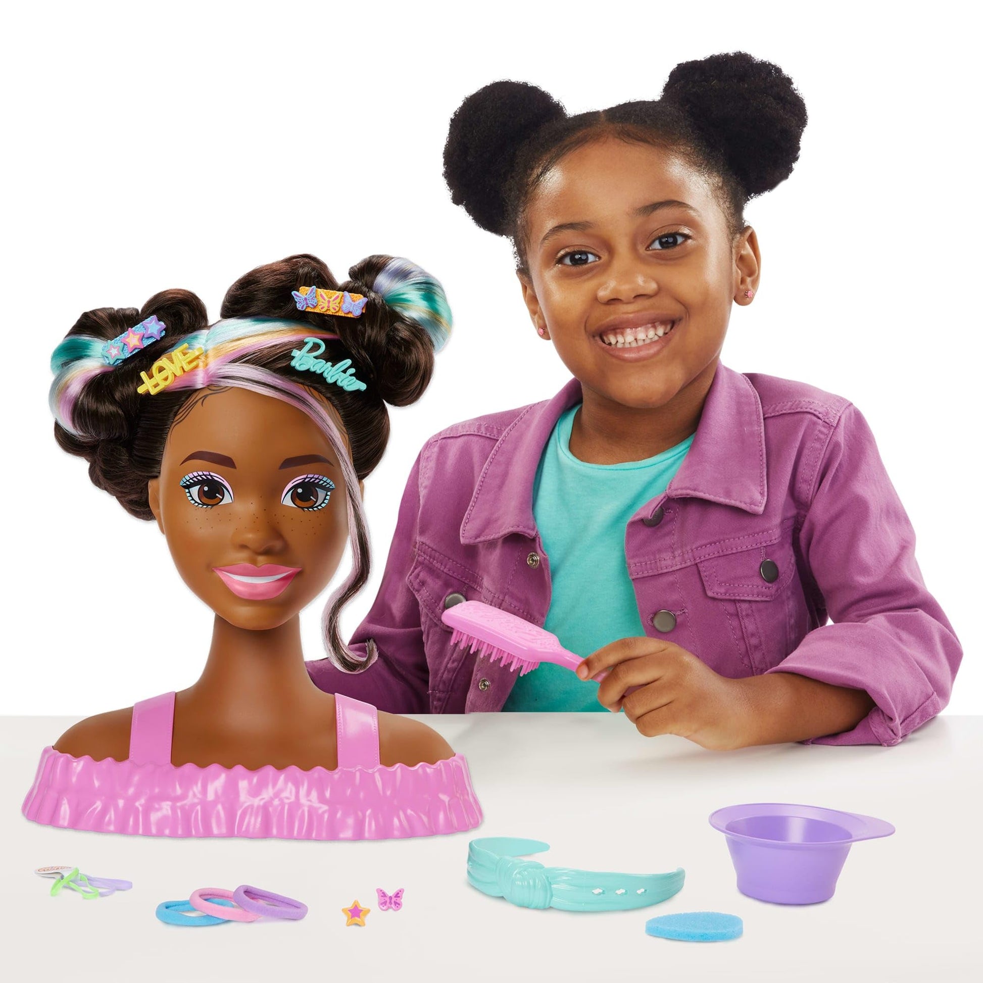 Barbie styling head doll with blonde hair and over 20 accessories, including star and butterfly color change hair clips.