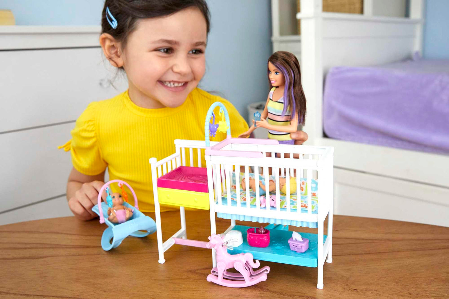 Barbie Nursery Playset featuring Skipper doll, two baby dolls, crib, and over 10 pieces of baby gear and toys.