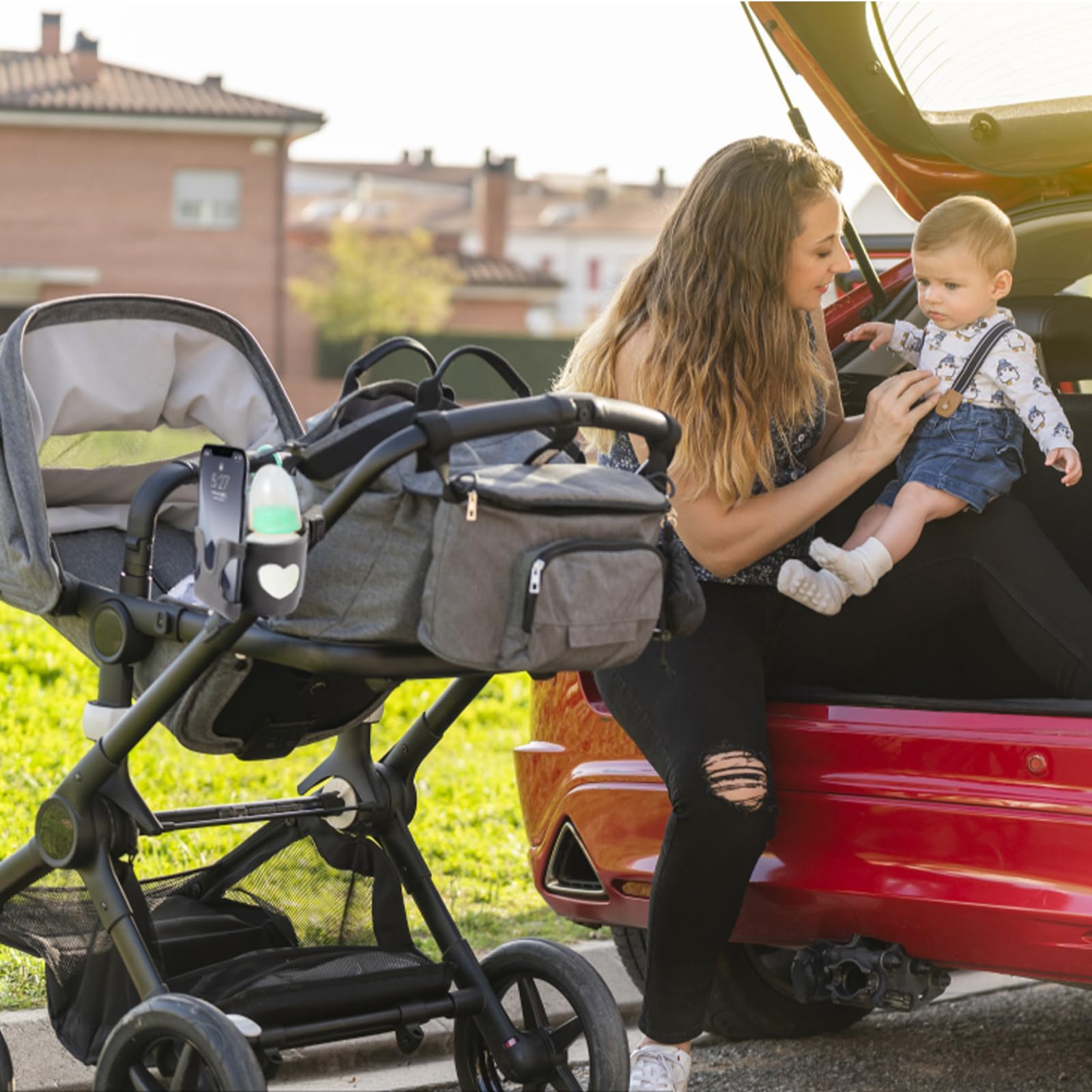 Black pram cup holder with phone holder, suitable for strollers, buggies, and bikes, designed by BAGUBDR for convenient hydration.