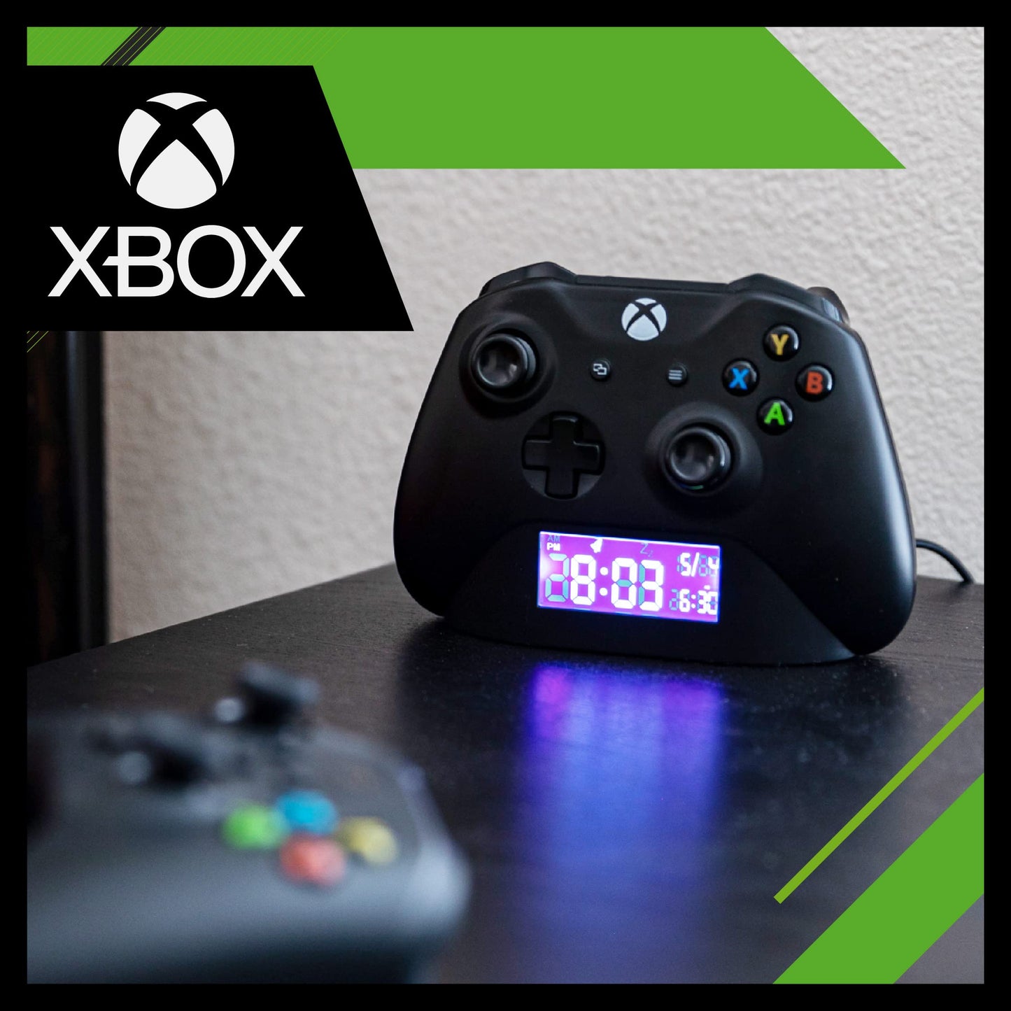Black Paladone Xbox controller alarm clock showing digital time and date, perfect for gamers' bedroom decor and gift ideas.
