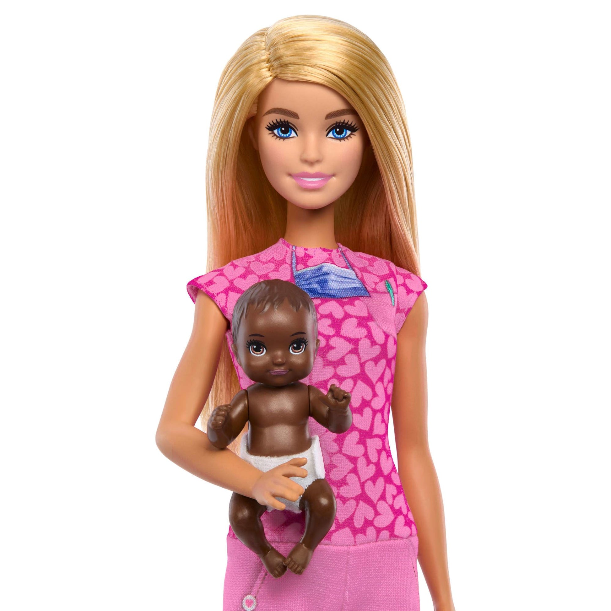 Barbie Baby Doctor doll with blonde hair wearing pink scrubs, includes baby accessories and furniture for imaginative play.