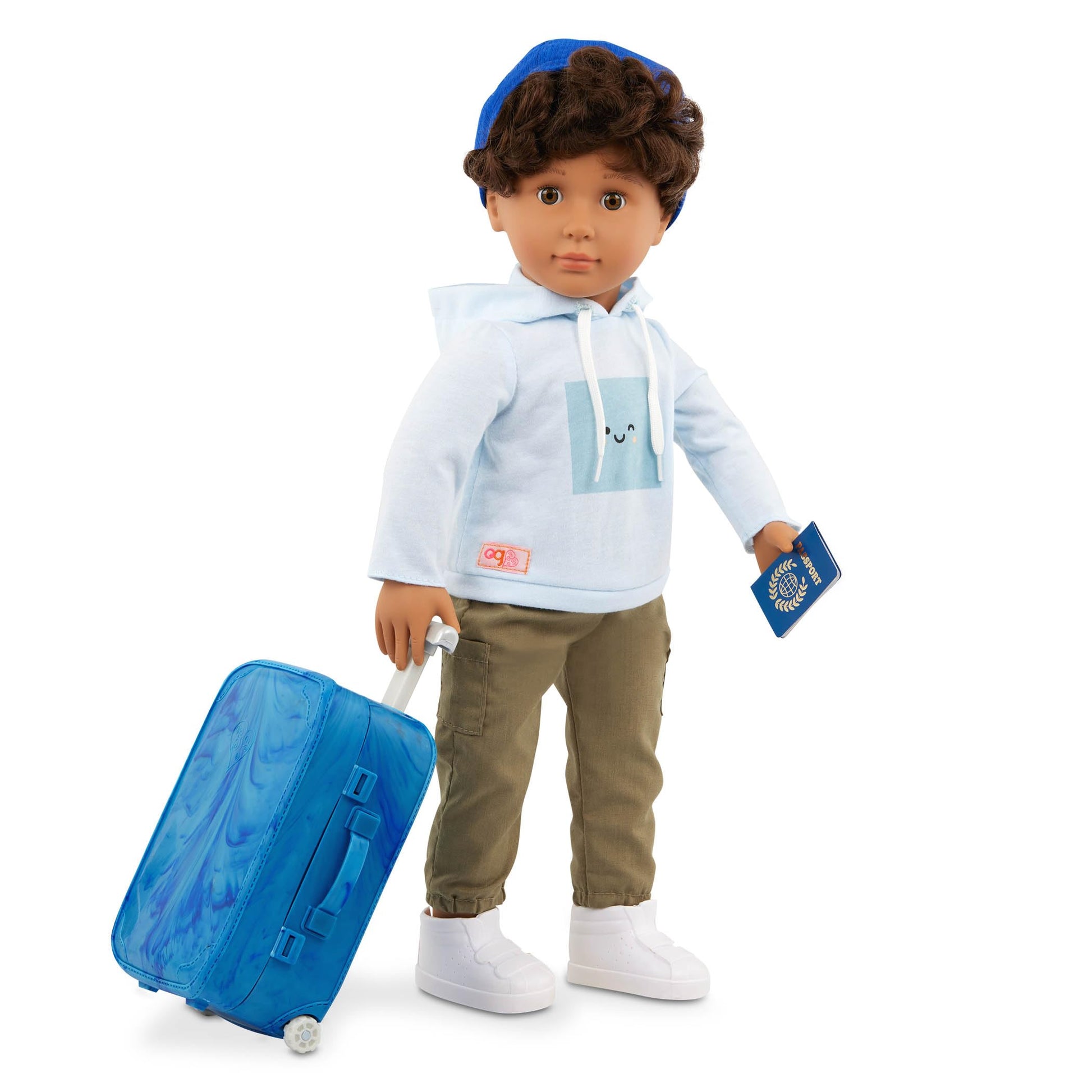 Our Generation Milo boy doll with travel accessories, including luggage, sunglasses, and passport, ideal for imaginative play.