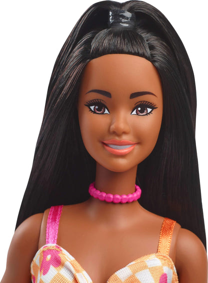 Barbie Fashionistas Doll #233 with black hair in a checkered orange and pink floral midi dress, necklace, and sandals.