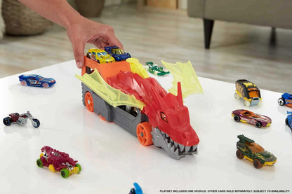 Hot Wheels Dragon Launch Transporter with a vivid dragon design and toy cars on a detailed truck setup.
