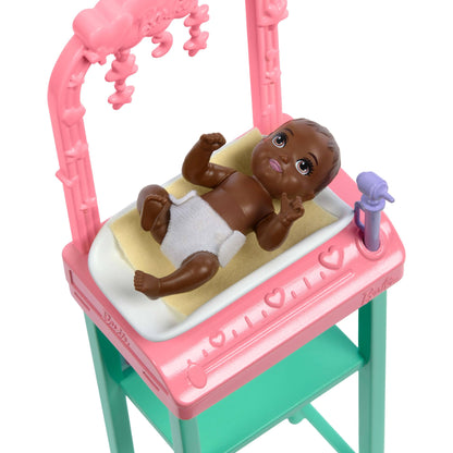 Barbie Baby Doctor doll with blonde hair in pink scrubs, includes baby accessories and furniture for imaginative play.