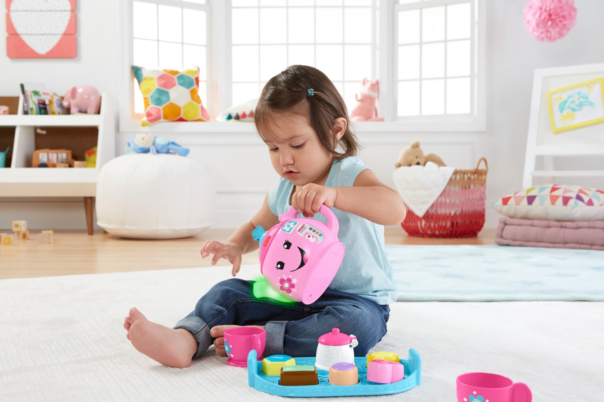 Fisher-Price Laugh & Learn Sweet Manners Tea Set for toddlers, with colorful cups, teapot, and utensils for pretend play.