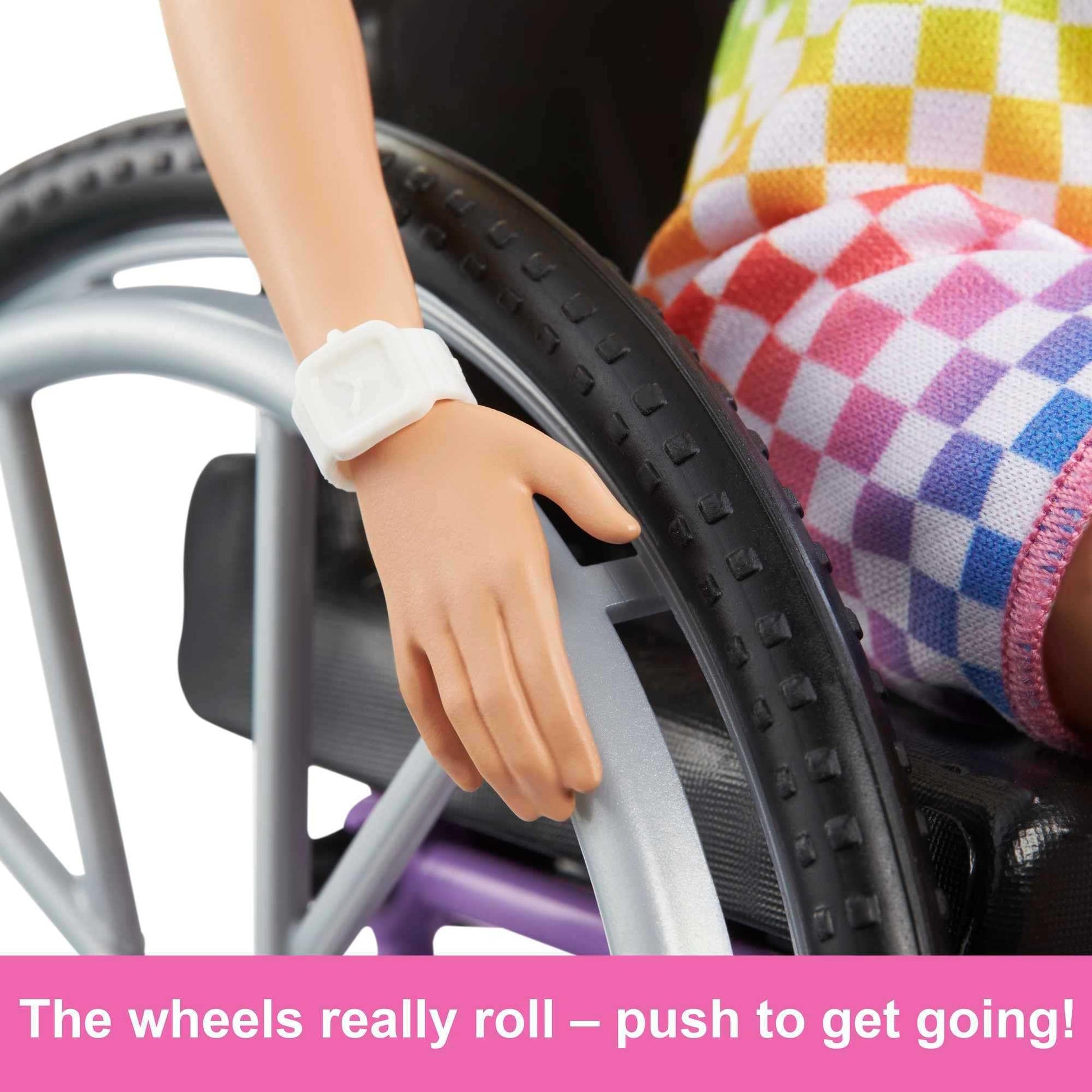 Barbie Fashionistas doll in a rainbow romper with a wheelchair and ramp, designed for imaginative play and inclusivity.