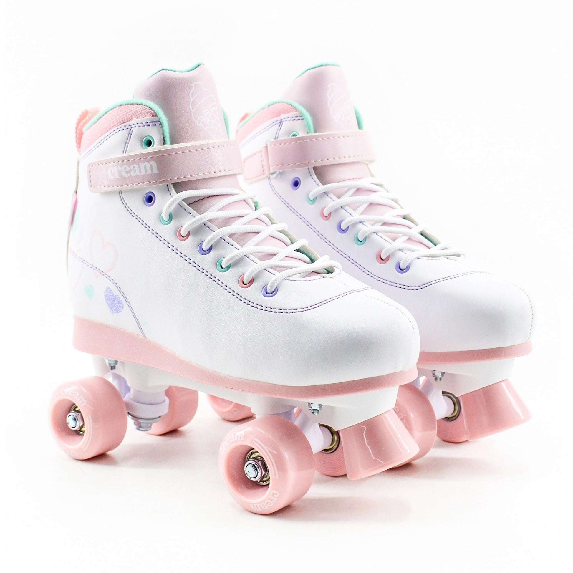 Cream Kids adjustable quad roller skates with white and pink hearts, featuring four wheels for balance and beginner-friendly fit.