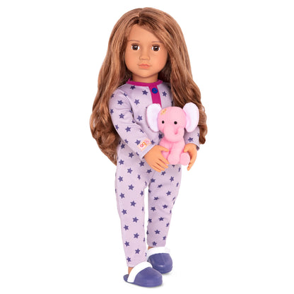 Our Generation Maria fashion doll in pink pyjama onesie holding an elephant plush toy, posed with her arms and legs visible.