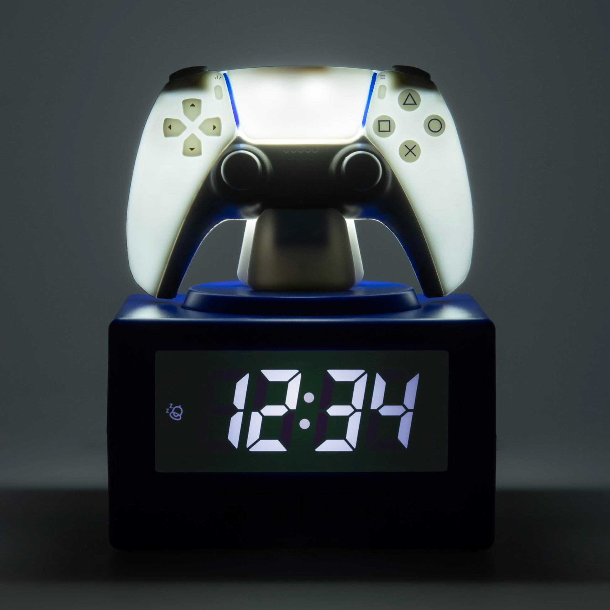 Paladone PlayStation DualSense controller digital alarm clock with night light, sleek gaming-themed bedroom décor for kids and teens.