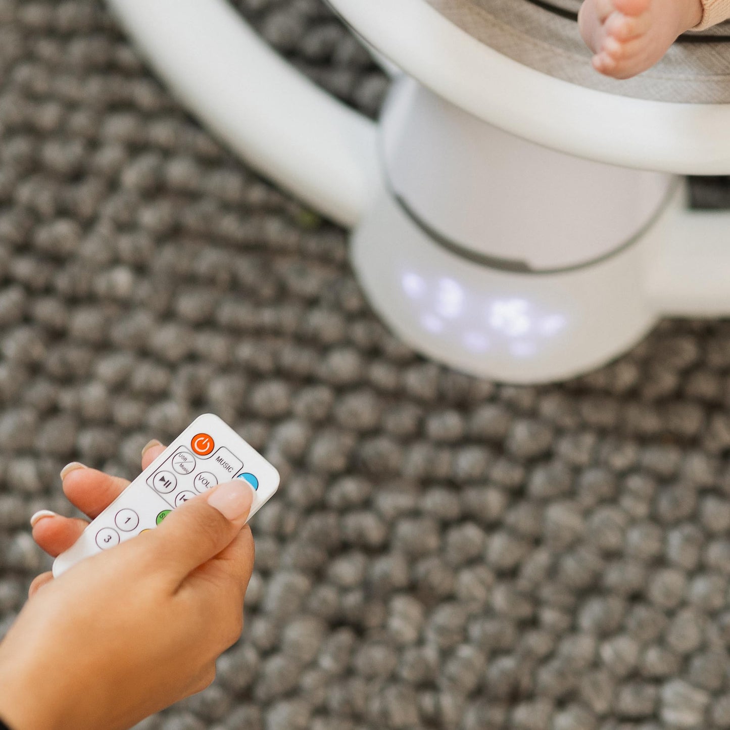 Nuby Connect baby swing chair in grey with toy bar, canopy, and remote control, suitable for infants from birth.
