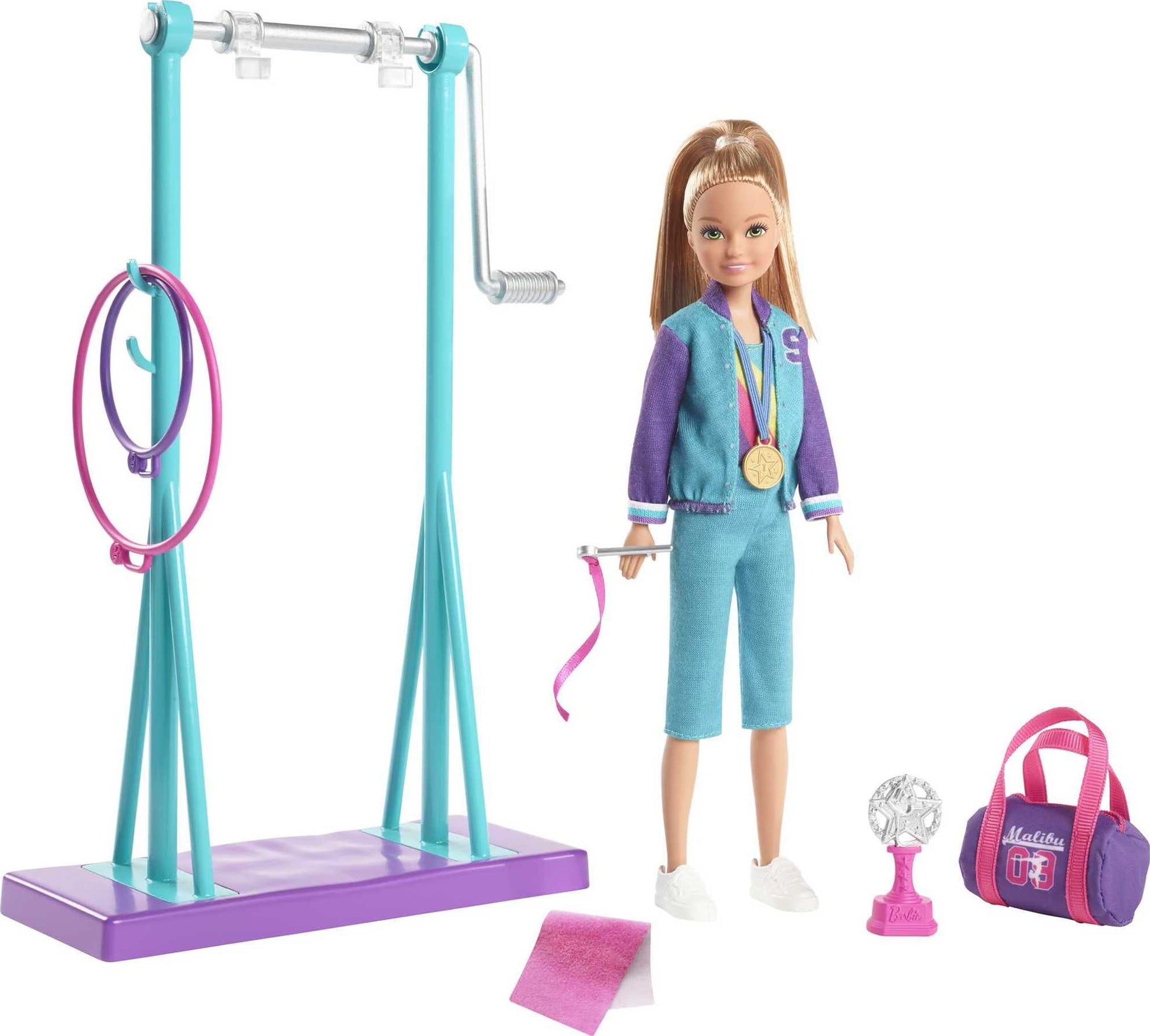 Barbie Team Stacie Doll with gymnastics playset, spinning bar, and 7 colorful themed accessories, in a vibrant scene.