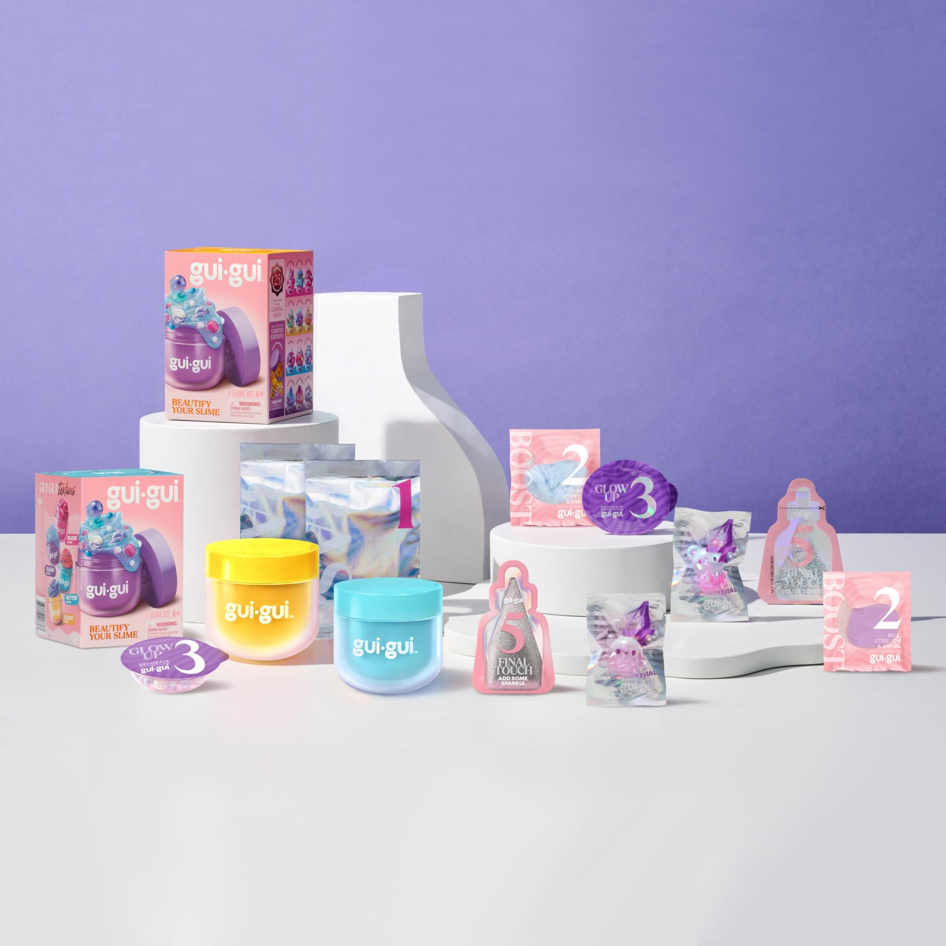 Two Gui Gui scented slimes in twin pack with butter and cloud textures, featuring vibrant colors and glossy, stretchy appearance.