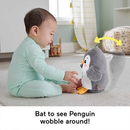 Fisher-Price plush penguin tummy time toy with flaps, wobble motion, and music for sensory play for babies 0+ months.