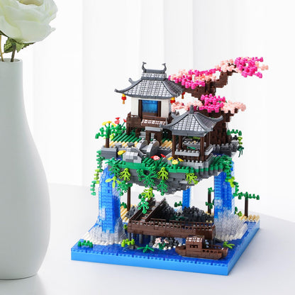 CAXIMSY Cherry Blossom Bonsai Treehouse model with 3300 building blocks, featuring intricate architecture and vibrant flowers.