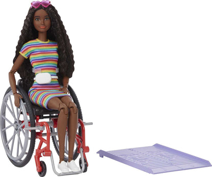 Barbie Fashionistas Doll #166 with wheelchair, crimped brunette hair, rainbow dress, white sneakers, sunglasses, and fanny pack.