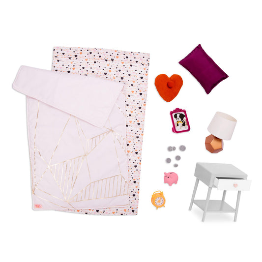 Our Generation 18-inch doll bedding set with colorful patterns and pillows for pretend play in a dollhouse.