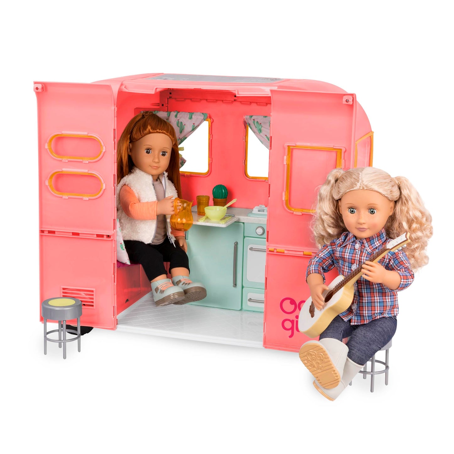 Our Generation pink camping trailer with kitchen and cooking accessories for 18-inch dolls, perfect for pretend play.