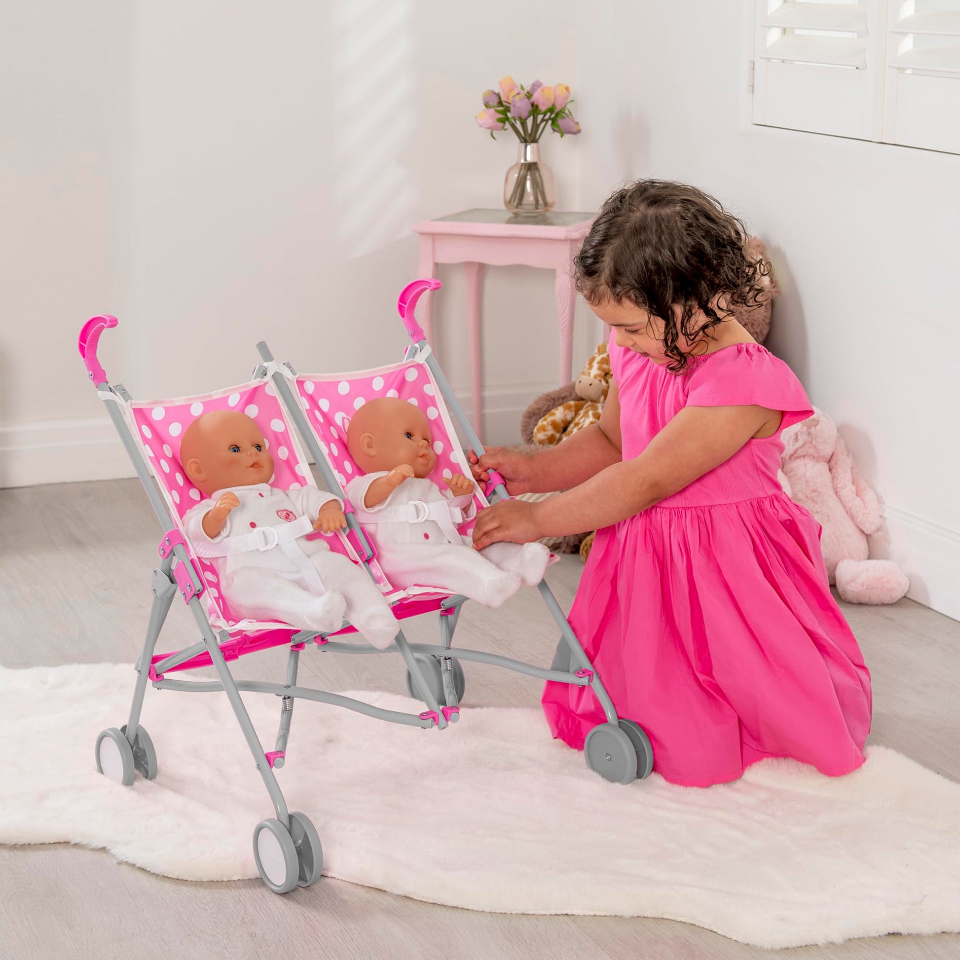 Pink polka dot Dolly Tots twin stroller for kids, lightweight double dolls pram with umbrella fold, ideal for role play for girls and boys