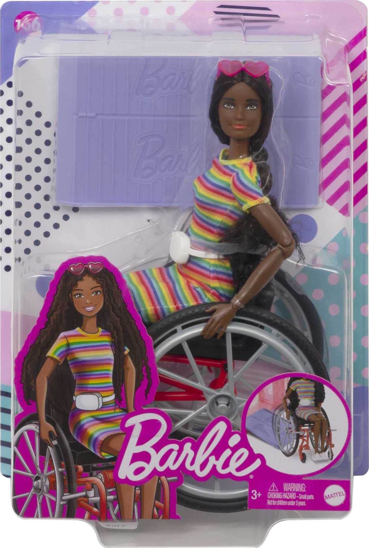 Barbie Fashionistas Doll #166 with wheelchair, crimped brunette hair, rainbow dress, white sneakers, sunglasses, and fanny pack.