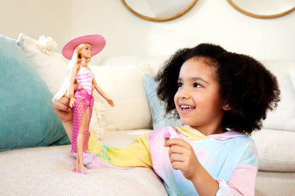 Blonde Barbie doll wearing a pink and white swimsuit, sun hat, tote bag, and beach-themed accessories.