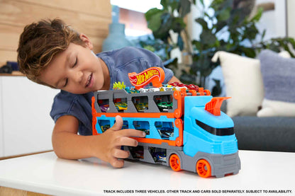 Hot Wheels Speedway Hauler Carrier with 3 cars and 6-foot drag race track for kids, featuring storage for 20+ cars.