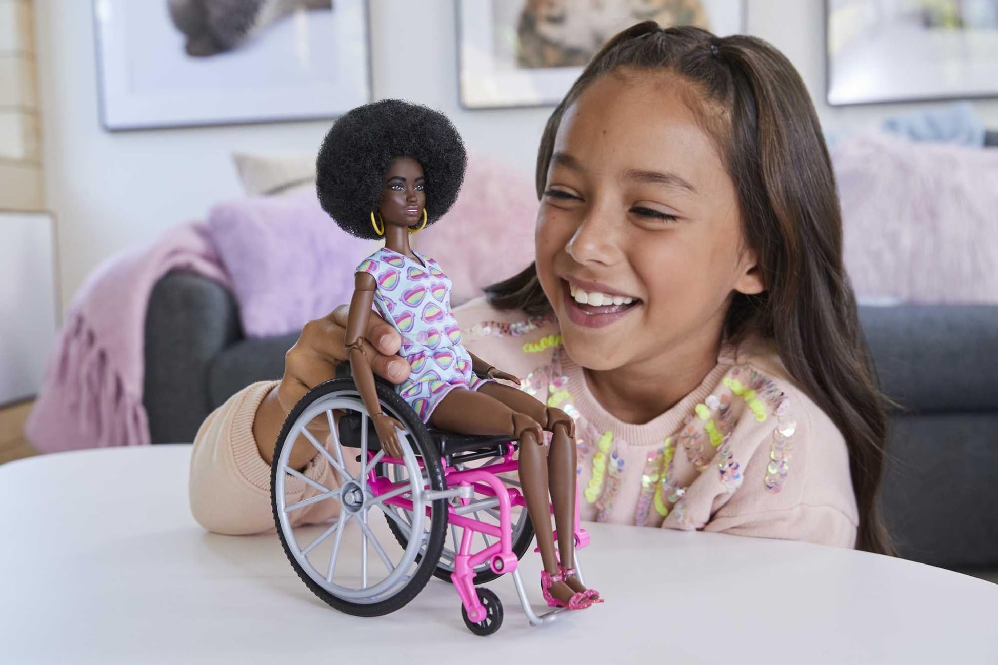 Barbie Fashionistas doll with curly black hair, wheelchair, ramp, and rainbow heart romper for imaginative play.